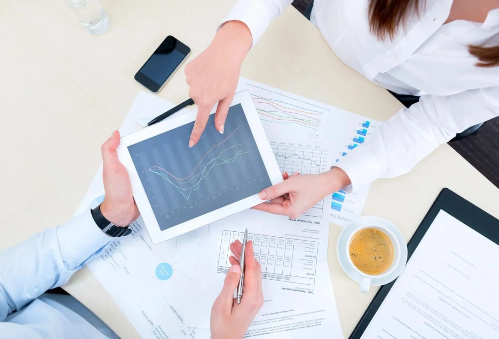 Business colleagues reviewing tablet with financial charts