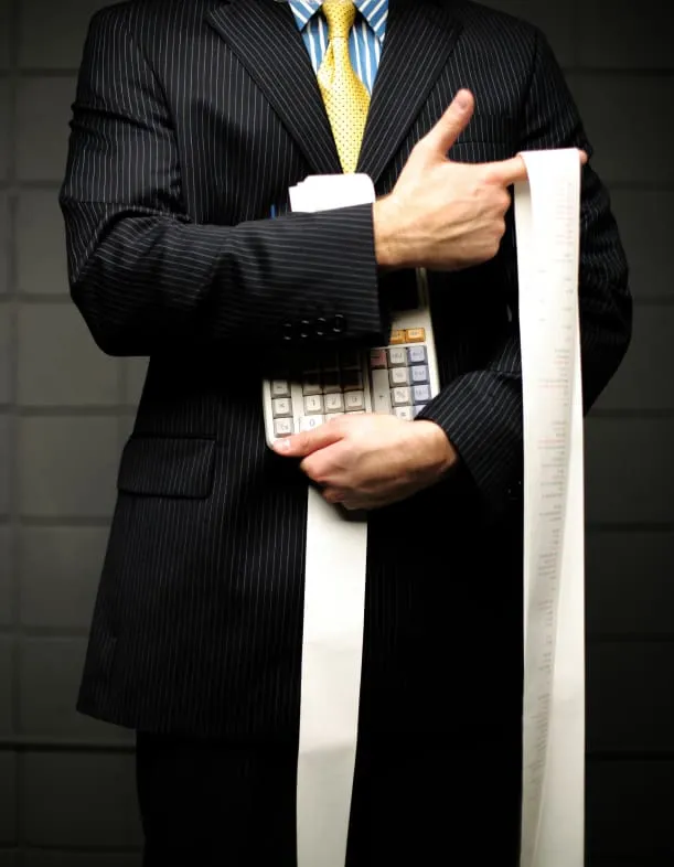 Businessman holding calculator and long receipt