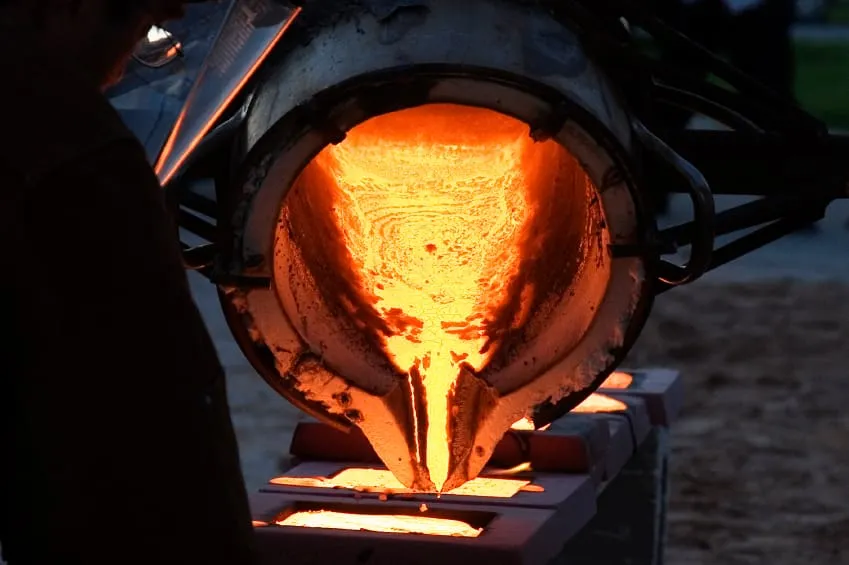 Molten metal being poured into molds