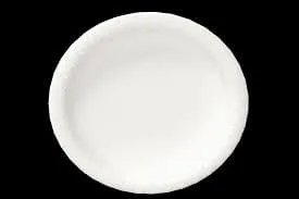 White round paper plate on black background