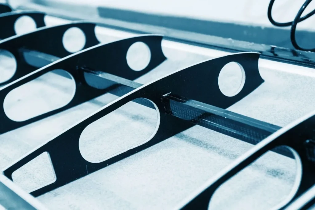 Black metal brackets with oval cutouts closeup
