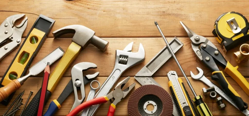 Assorted hand tools on wooden workbench