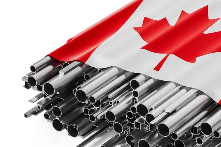 Canadian flag over metal pipes